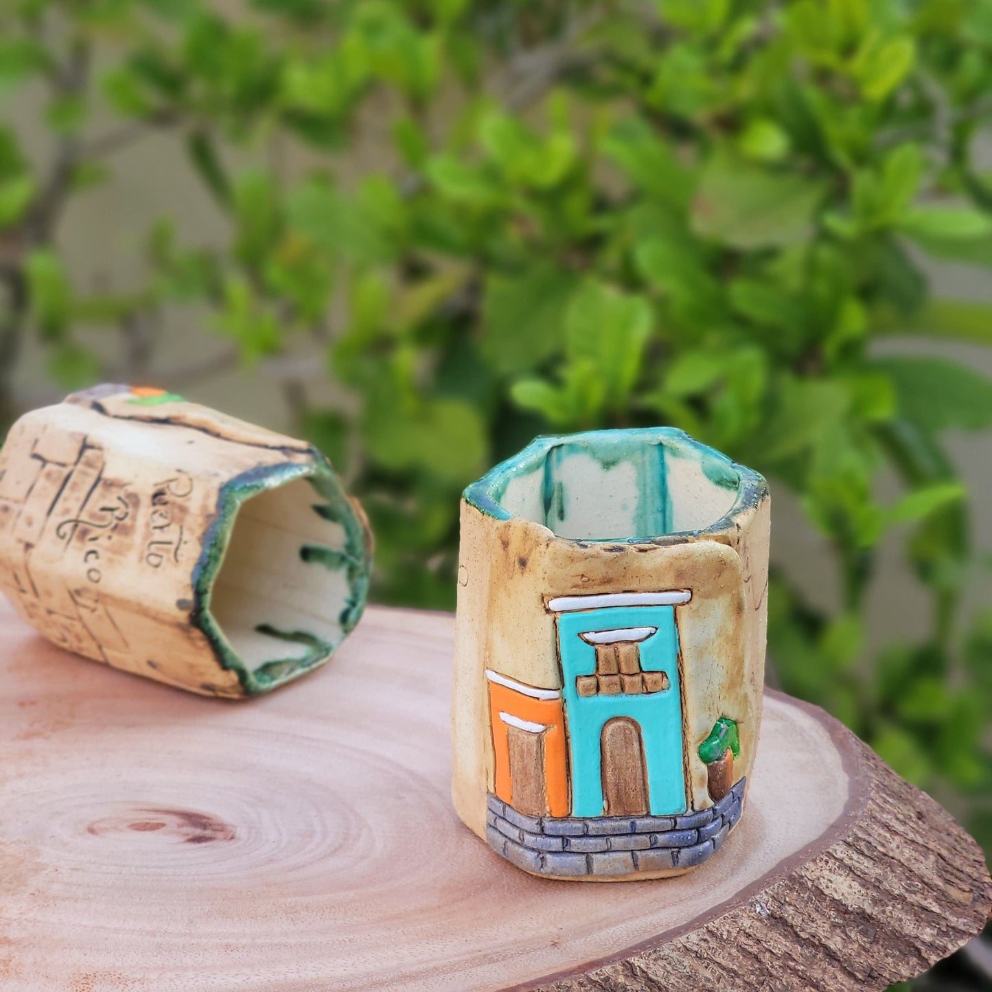 Decorative colonial facades attached to a wooden post with blurred greenery in the background