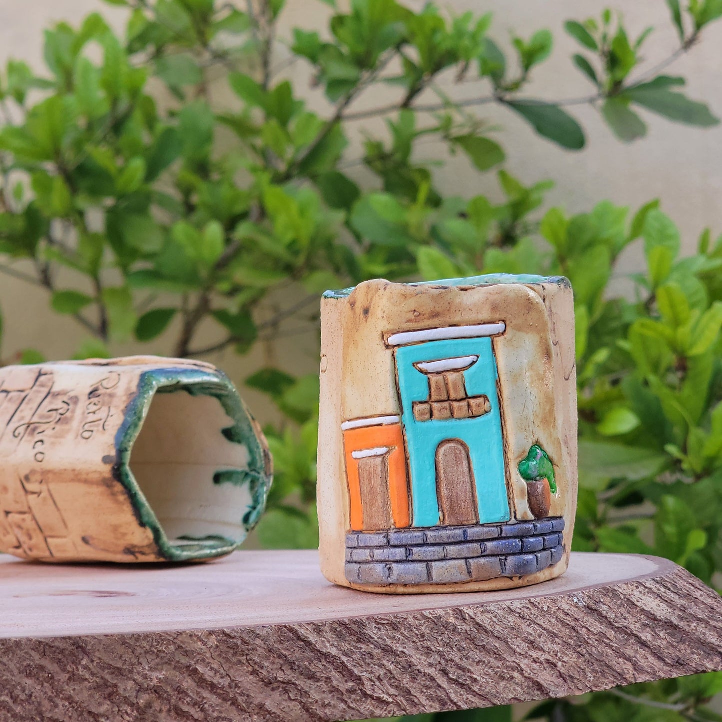 Decorative colonial facades attached to a wooden post with greenery in the background