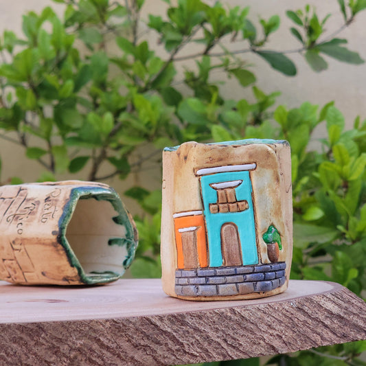 Decorative colonial facades attached to a wooden post with greenery in the background